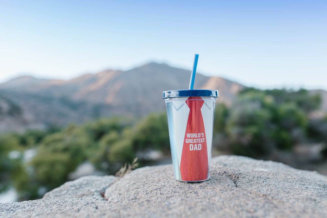 services-01 Focus on a personalized tumbler with a mountain backdrob, ideal for Father's Day.